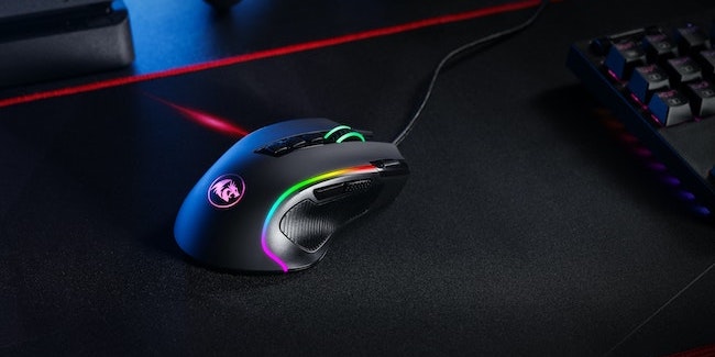 Gaming mouse sitting on mat with multiple buttons