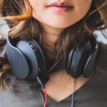 woman using headphones to listen to music