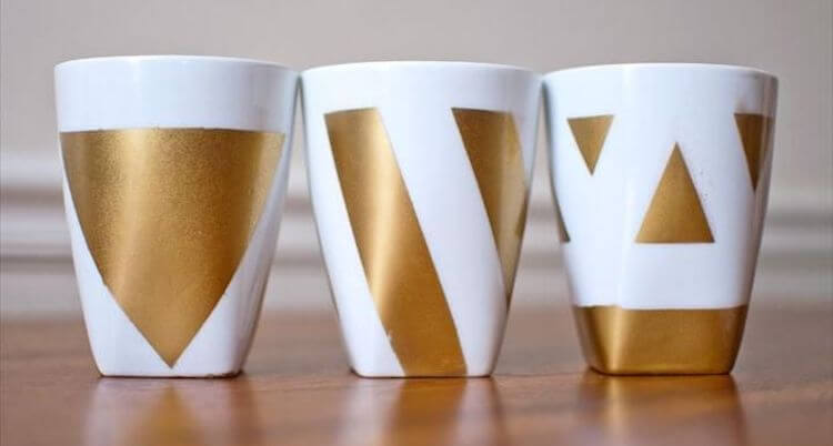 Gold triangular designs added to 3 mugs using a stencil and spray paint.