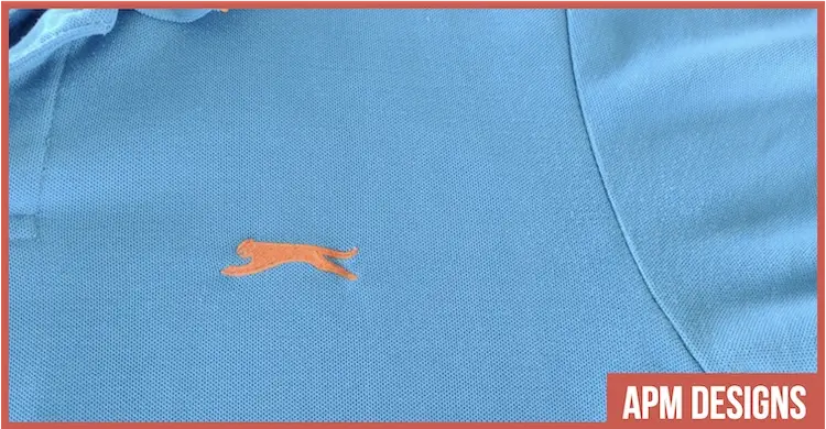 Blue polo neck shirt with orange embroidered logo by Slazenger -  copyright APM DesignsⒸ