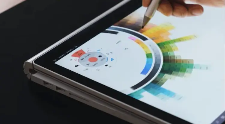 Person using a touchscreen tablet to select colors that contrast.
