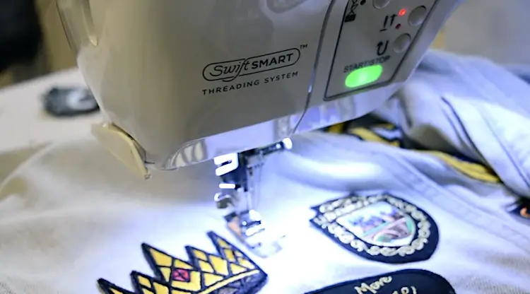 machine sewing patch on backpack