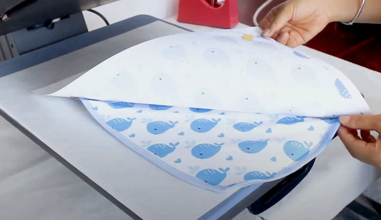 Transferring sublimation designs onto a baby big using heat press