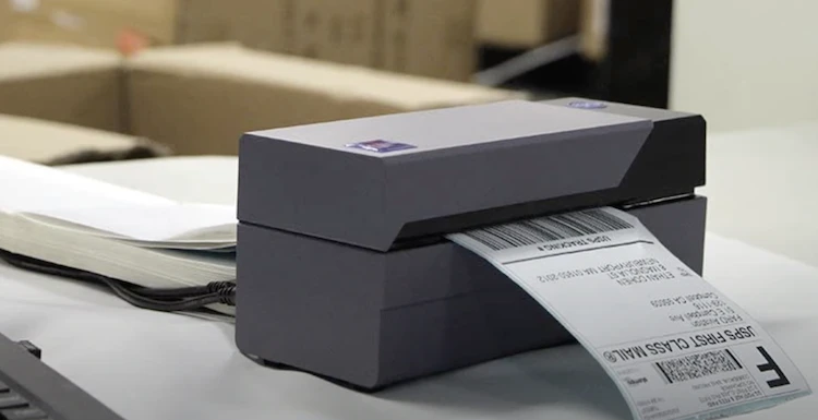 Compact direct thermal printer used in a warehouse printing first class labels 