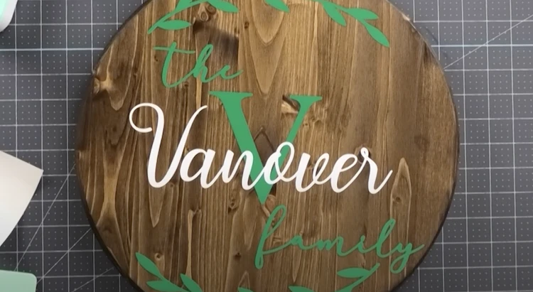 Temporary vinyl with the text "The Vanover" applied on a wooden cutting board.