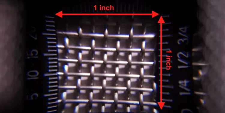 A ruler used to determine the number of opening in a mesh within 1 inch square area.