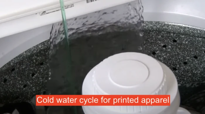 Washing machine being filled up with cooler water to protect design apparel from cracking